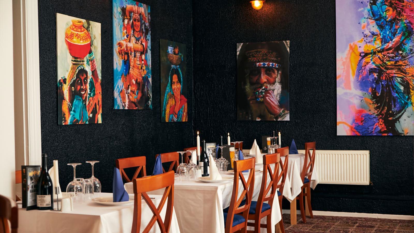 Private dining alcove framed by hand-painted portraits